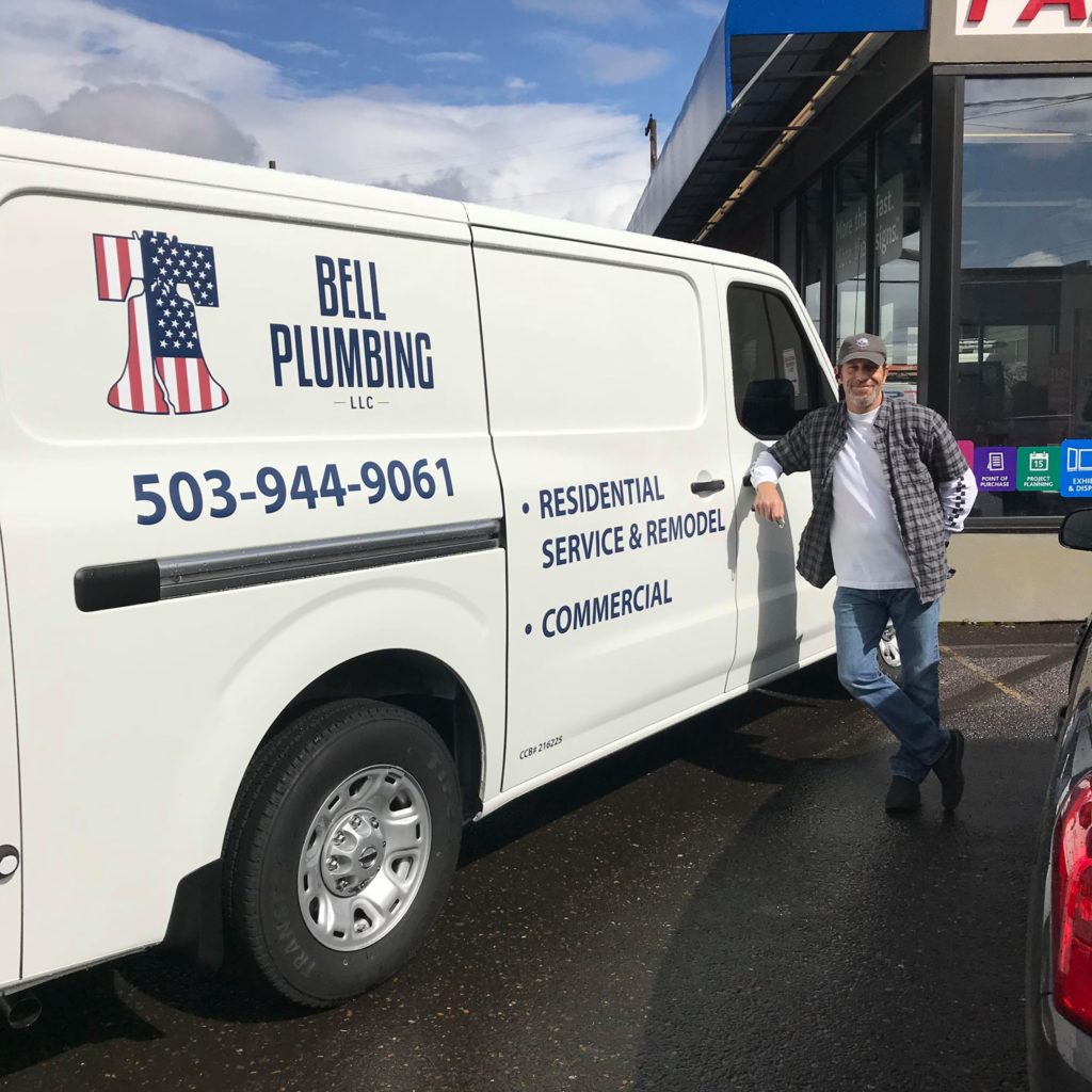 Joe Bell standing next to a Bell Plumbing van.